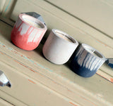 Stylish concrete pots with seasonal hand-poured candles by Carlos Dominguez