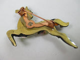 Galloping horse jewelled brooch in yellow and gold by Annie Sherburne